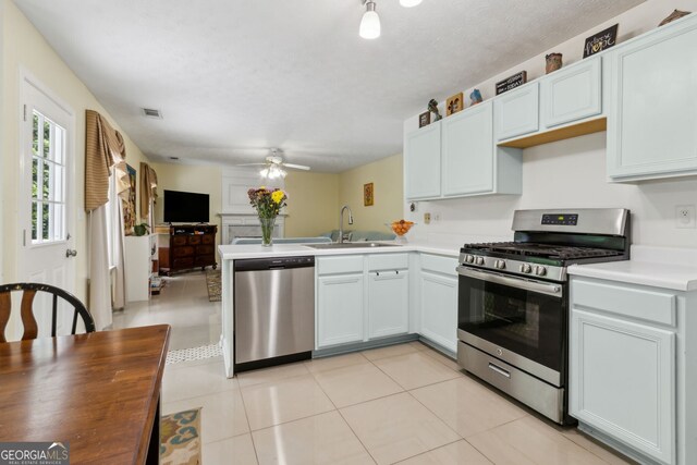 570 White Stag Ct, Suwanee, GA 30024 - kitchen featuring appliances with stainless steel finishes, a peninsula, ceiling fan, open floor plan, and light countertops