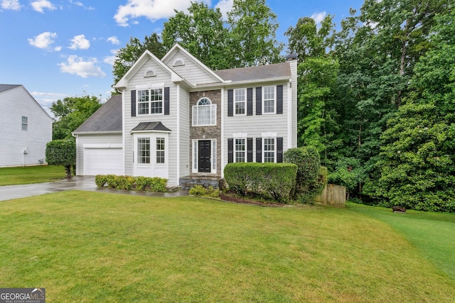570 White Stag Ct, Suwanee, GA 30024 - view of front of property featuring a chimney, concrete driveway, a front lawn, and stone siding