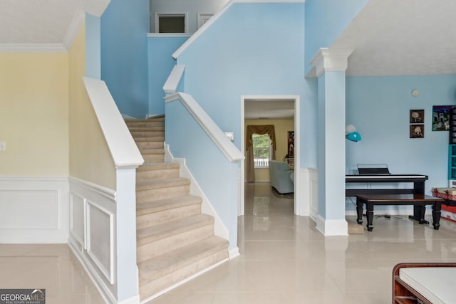 570 White Stag Ct, Suwanee, GA 30024 - staircase featuring wainscoting, tile patterned floors, decorative columns, and ornamental molding