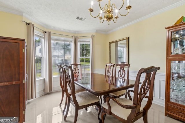 570 White Stag Ct, Suwanee, GA 30024 - dining space featuring a chandelier, light tile patterned floors, crown molding, a textured ceiling, and wainscoting