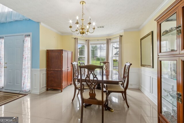570 White Stag Ct, Suwanee, GA 30024 - dining space featuring a chandelier, a decorative wall, a wainscoted wall, a textured ceiling, and light tile patterned floors
