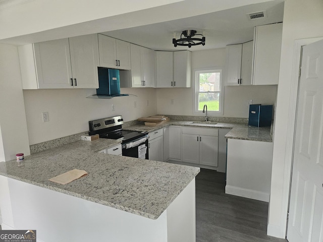 1408 Bethune St, Waycross, GA 31501 - kitchen featuring stainless steel range with electric cooktop, a peninsula, light stone countertops, and white cabinetry