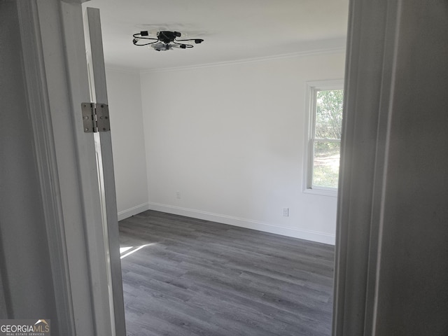 1408 Bethune St, Waycross, GA 31501 - spare room featuring crown molding, baseboards, and dark wood finished floors