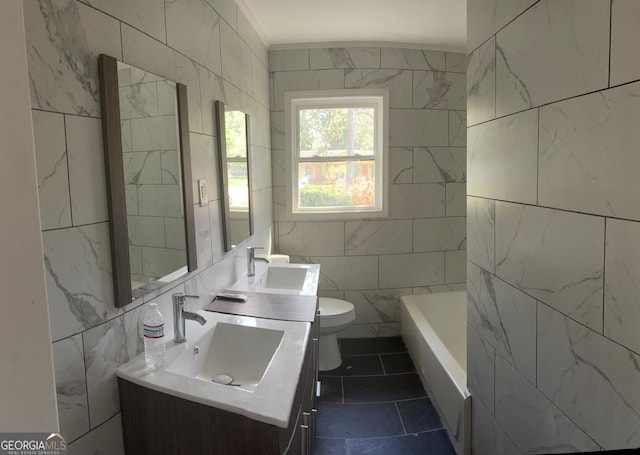 1408 Bethune St, Waycross, GA 31501 - full bath featuring tile walls, toilet, vanity, a bathtub, and tile patterned floors