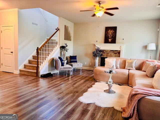38 Lavender Ct, Dallas, GA 30132 - living area with wood finished floors, stairway, ceiling fan, baseboards, and a brick fireplace