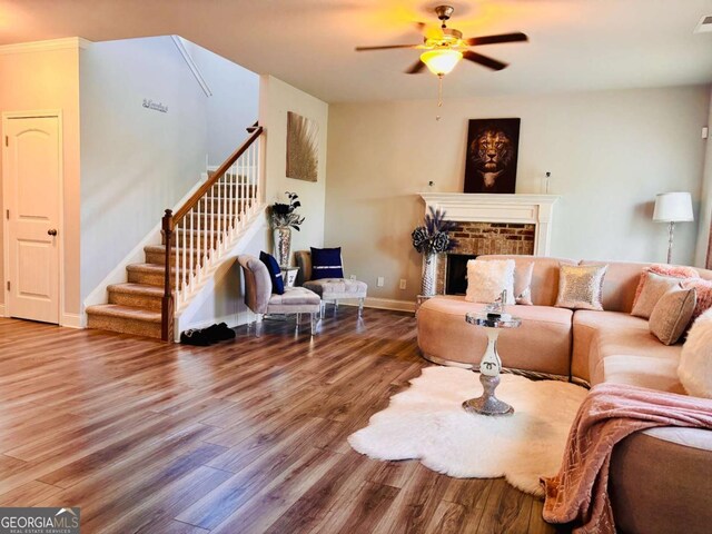 38 Lavender Ct, Dallas, GA 30132 - living room with wood finished floors, stairs, a ceiling fan, and a fireplace