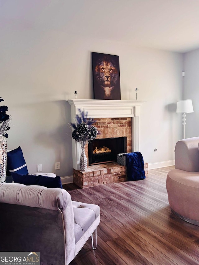 38 Lavender Ct, Dallas, GA 30132 - living area with wood finished floors, a brick fireplace, and baseboards
