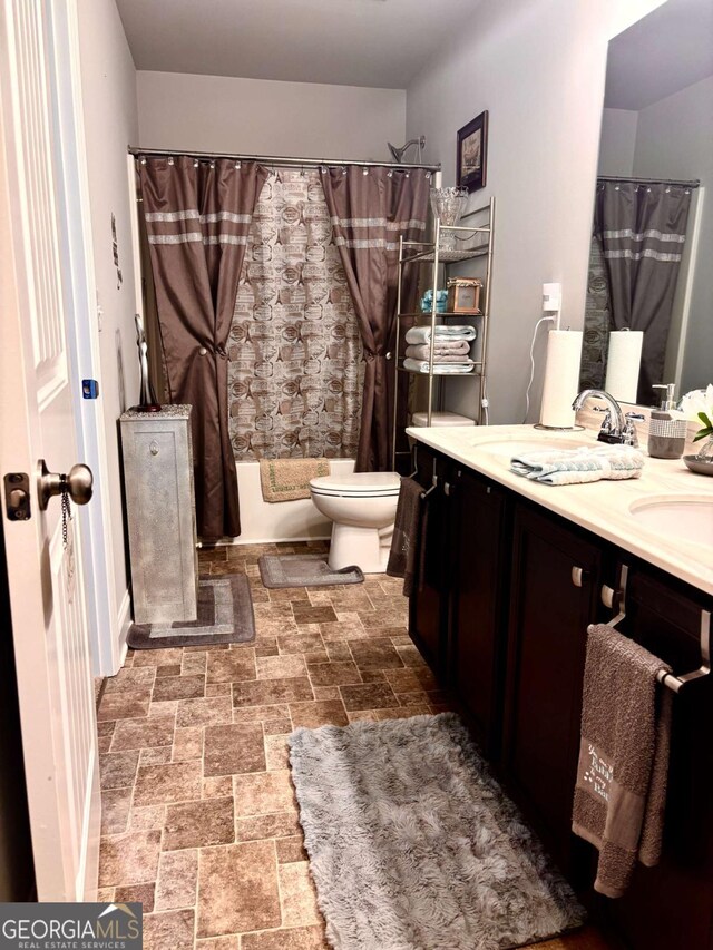 38 Lavender Ct, Dallas, GA 30132 - full bath featuring double vanity, shower / tub combo, and stone finish flooring