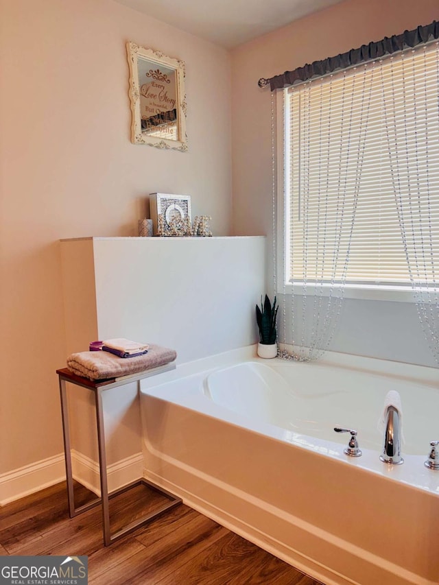 38 Lavender Ct, Dallas, GA 30132 - full bath featuring wood finished floors, a garden tub, and baseboards