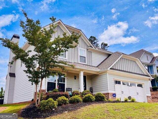 38 Lavender Ct, Dallas, GA 30132 - craftsman-style home featuring board and batten siding, a garage, brick siding, and a front lawn