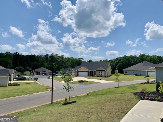 1146 Barrington Place Way, Macon, GA 31220 - view of green lawn featuring a residential view, concrete driveway, and a garage