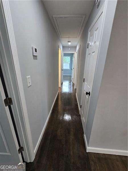 766 Longleaf Dr, Forest Park, GA 30297 - hallway featuring attic access, wood finished floors, and baseboards