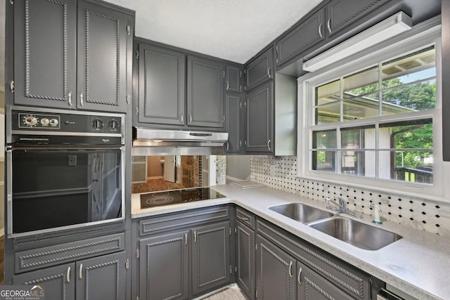 2676 Abington Dr, Snellville, GA 30078 - kitchen featuring black appliances, a sink, light countertops, and healthy amount of natural light