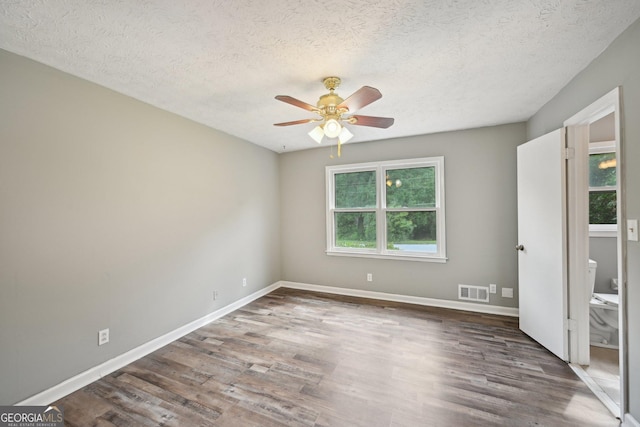 2676 Abington Dr, Snellville, GA 30078 - unfurnished bedroom featuring wood finished floors, a textured ceiling, baseboards, and a ceiling fan