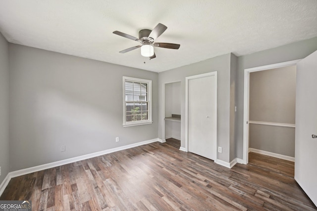 2676 Abington Dr, Snellville, GA 30078 - unfurnished bedroom featuring wood finished floors, baseboards, and a ceiling fan