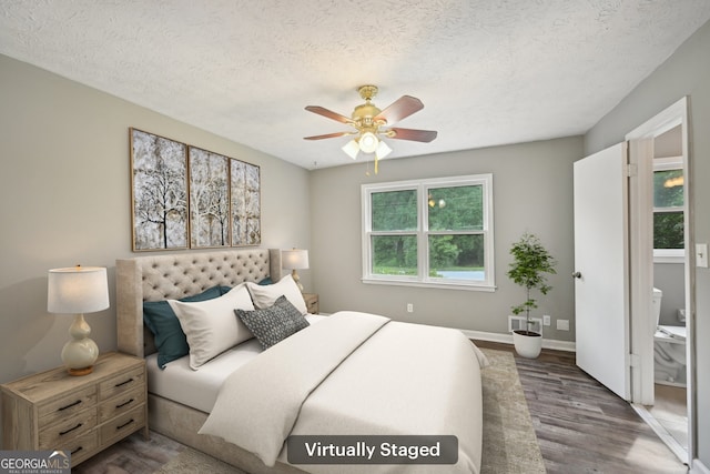 2676 Abington Dr, Snellville, GA 30078 - bedroom with dark wood finished floors, a textured ceiling, ceiling fan, and baseboards