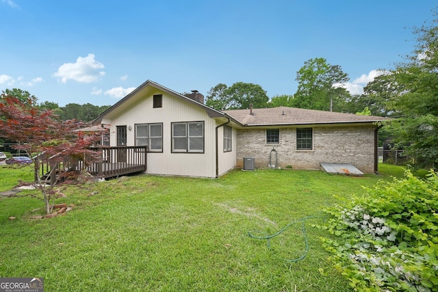 2676 Abington Dr, Snellville, GA 30078 - back of house with a chimney, a wooden deck, cooling unit, and brick siding