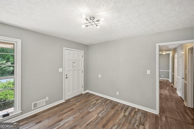 2676 Abington Dr, Snellville, GA 30078 - spare room with wood finished floors, a textured ceiling, a chandelier, and baseboards