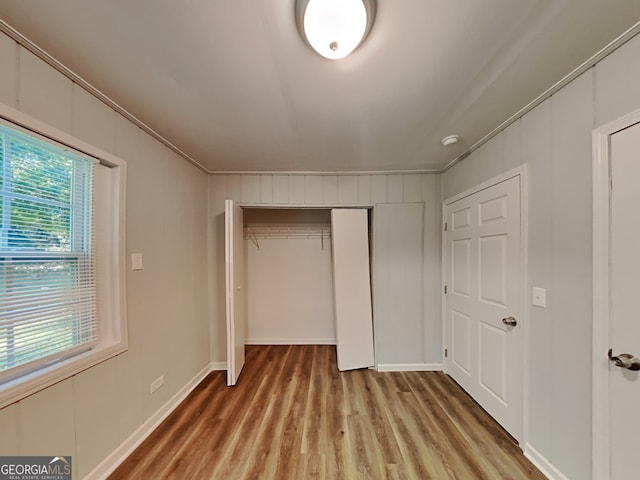 7054 Chappell Cir, Atlanta, GA 30360 - unfurnished bedroom with light wood finished floors, a closet, crown molding, and baseboards