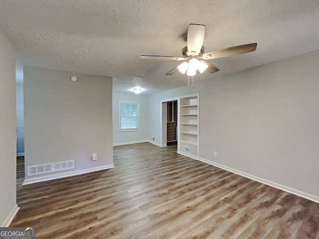 7054 Chappell Cir, Atlanta, GA 30360 - spare room with a ceiling fan, baseboards, wood finished floors, built in shelves, and a textured ceiling