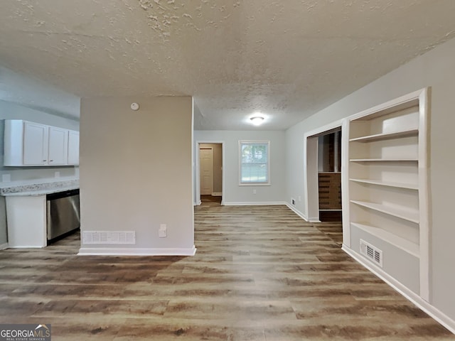 7054 Chappell Cir, Atlanta, GA 30360 - unfurnished living room with a textured ceiling, light wood finished floors, baseboards, and built in features