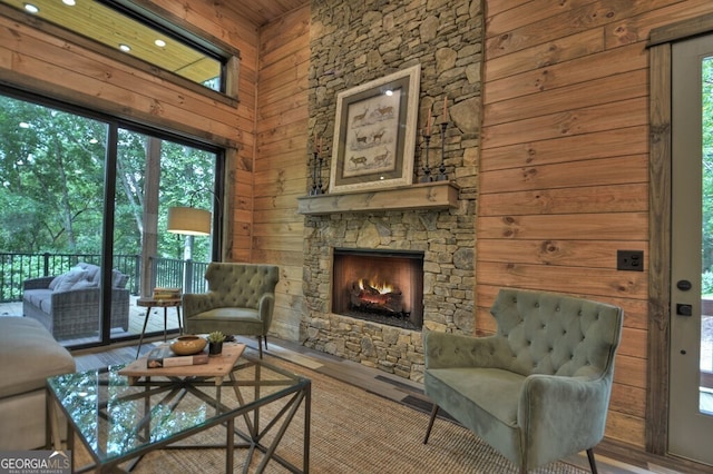 968 Hidden Valley Dr, Morganton, GA 30560 - living room featuring a stone fireplace, wood walls, and wood finished floors