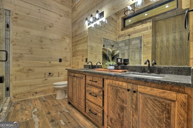 968 Hidden Valley Dr, Morganton, GA 30560 - full bath featuring double vanity, toilet, a stall shower, wood finished floors, and wooden walls