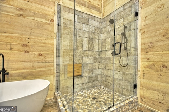 968 Hidden Valley Dr, Morganton, GA 30560 - bathroom with a soaking tub, a stall shower, wood walls, and wood finished floors