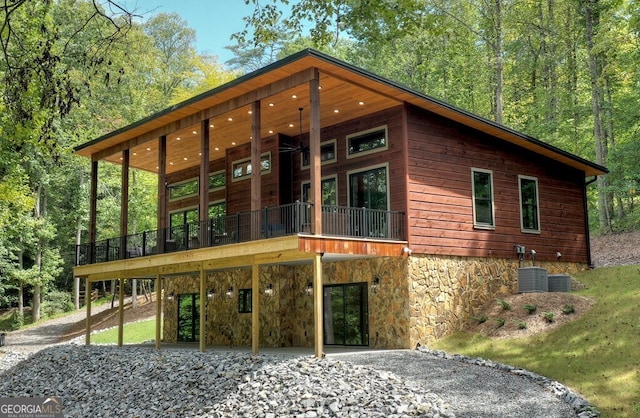 968 Hidden Valley Dr, Morganton, GA 30560 - view of front of home featuring a carport, central air condition unit, a deck, and stone siding