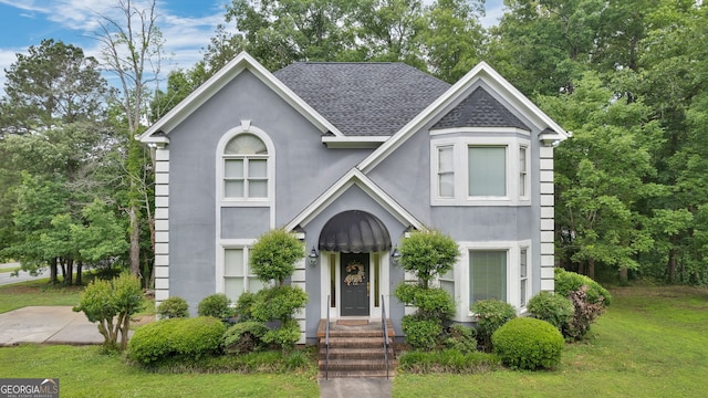 224 Rolling Oaks Dr, Rome, GA 30165 - view of front facade with stucco siding, a front lawn, and a shingled roof