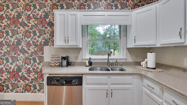 224 Rolling Oaks Dr, Rome, GA 30165 - kitchen with dishwasher, wallpapered walls, a sink, white cabinets, and tasteful backsplash