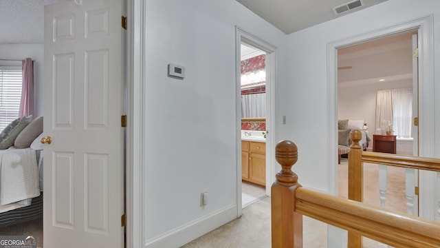 224 Rolling Oaks Dr, Rome, GA 30165 - hallway with baseboards, light carpet, a textured ceiling, and a sink
