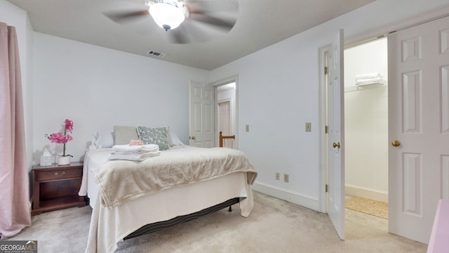 224 Rolling Oaks Dr, Rome, GA 30165 - bedroom with light colored carpet, a walk in closet, a ceiling fan, and baseboards