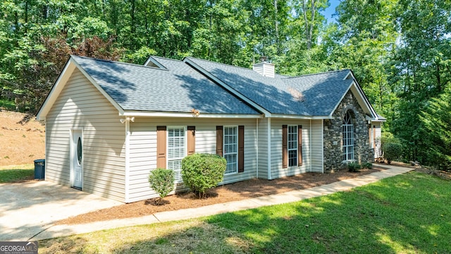 710 Newton Rd, Lagrange, GA 30240 - view of front facade featuring a shingled roof, a chimney, stone siding, and a front lawn