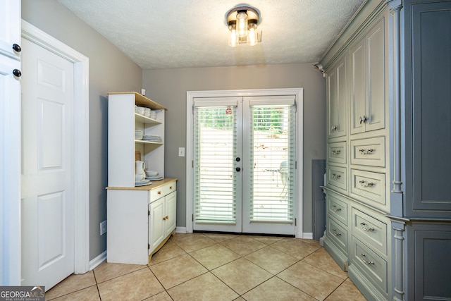 710 Newton Rd, Lagrange, GA 30240 - kitchen with open shelves, a textured ceiling, light tile patterned flooring, light countertops, and french doors