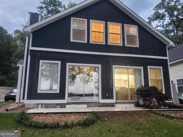 393 Arrowhead Trl, Eatonton, GA 31024 - back of house featuring a chimney and board and batten siding