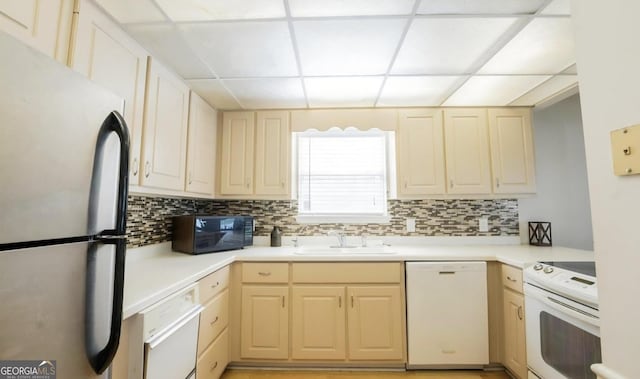 393 Arrowhead Trl, Eatonton, GA 31024 - kitchen with white appliances, a sink, a paneled ceiling, decorative backsplash, and light countertops