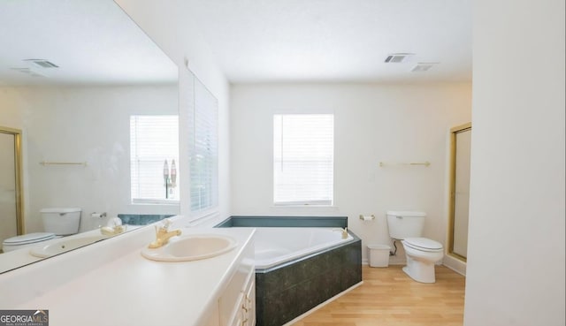 393 Arrowhead Trl, Eatonton, GA 31024 - bathroom with toilet, wood finished floors, a bath, and an enclosed shower