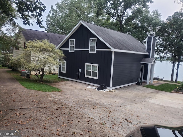 393 Arrowhead Trl, Eatonton, GA 31024 - view of property exterior with a chimney, a patio area, and a shingled roof