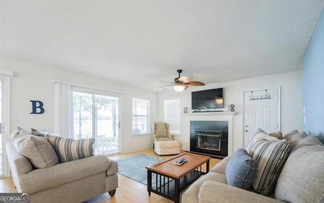 393 Arrowhead Trl, Eatonton, GA 31024 - living room featuring a ceiling fan, a tile fireplace, and wood finished floors