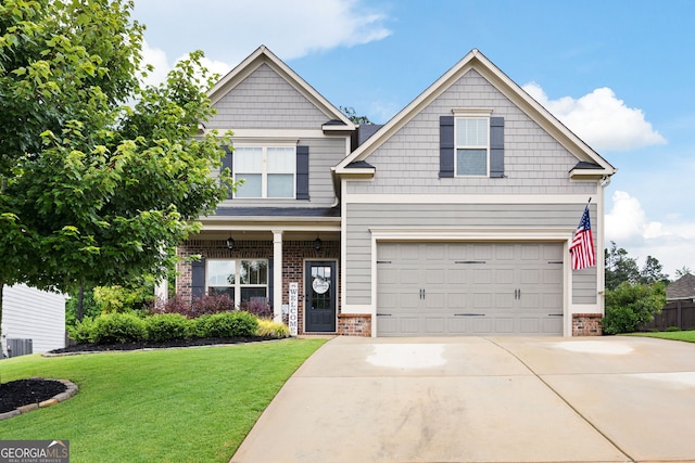 372 Cobblestone Trl, Dallas, GA 30157 - craftsman house with brick siding, a front lawn, an attached garage, driveway, and central AC