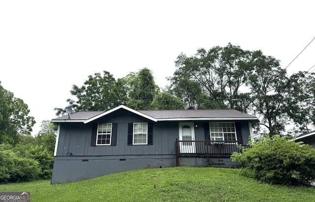101 Sunset Ln, Newnan, GA 30263 - view of front of home featuring crawl space, covered porch, a front lawn, and board and batten siding