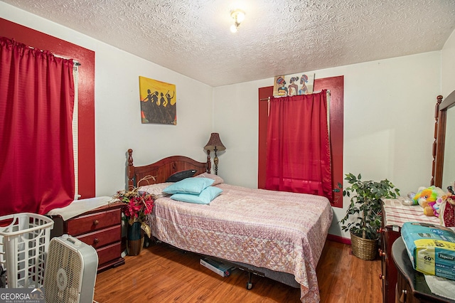 564 Peters St, Statham, GA 30666 - bedroom featuring wood finished floors and a textured ceiling