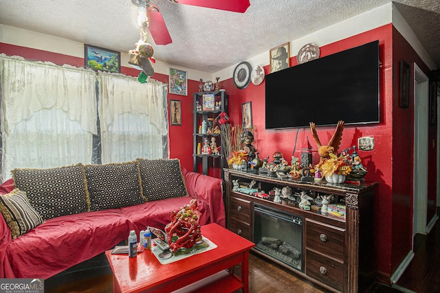 564 Peters St, Statham, GA 30666 - living room featuring dark wood-style floors, a textured ceiling, and ceiling fan