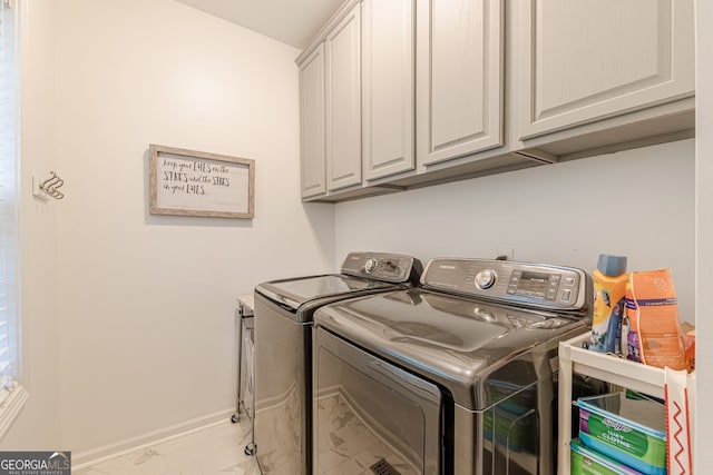 5767 Wembley Dr, Douglasville, GA 30135 - washroom featuring washing machine and dryer, cabinet space, and marble look tiles