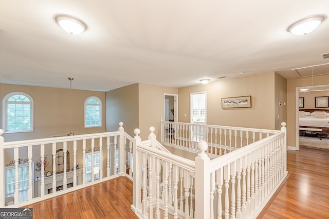 5767 Wembley Dr, Douglasville, GA 30135 - hall with attic access, wood finished floors, and an upstairs landing