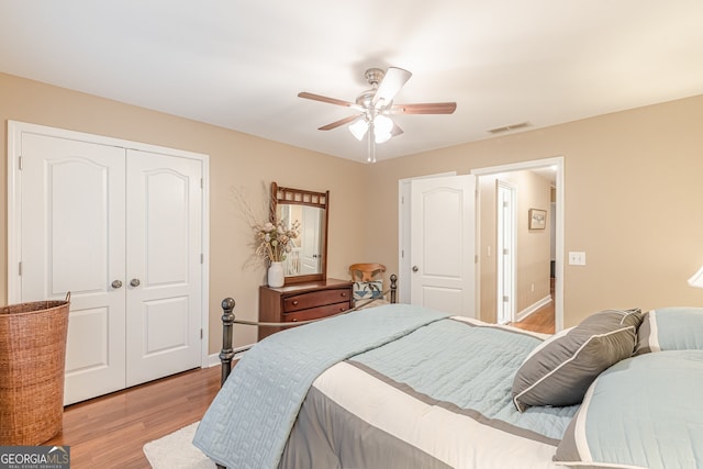 5767 Wembley Dr, Douglasville, GA 30135 - bedroom with a closet, light wood-type flooring, and a ceiling fan