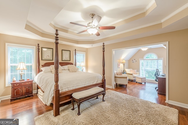 5767 Wembley Dr, Douglasville, GA 30135 - bedroom featuring a tray ceiling, ornamental molding, wood-type flooring, and ceiling fan