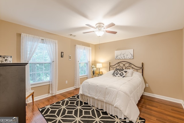 5767 Wembley Dr, Douglasville, GA 30135 - bedroom with wood finished floors, multiple windows, and a ceiling fan