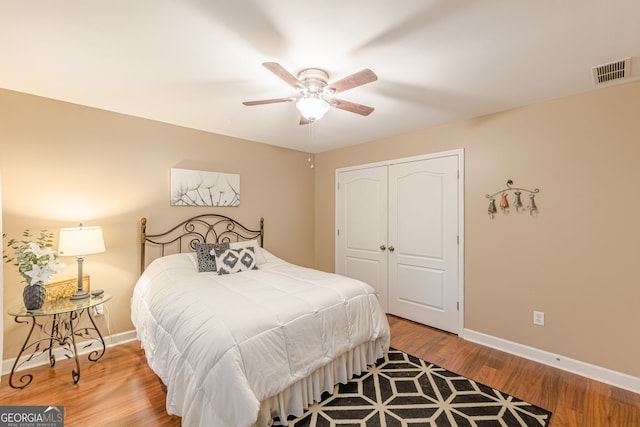 5767 Wembley Dr, Douglasville, GA 30135 - bedroom featuring a closet, wood finished floors, and a ceiling fan